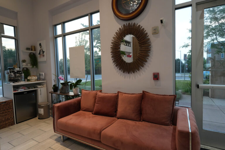 Client lounge with velvet sofa at MKP Salon